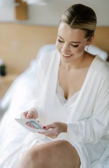 Bride in a white robe getting ready before the ceremony